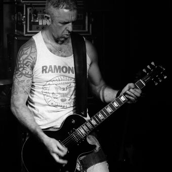 Alan playing guitar, black and white.